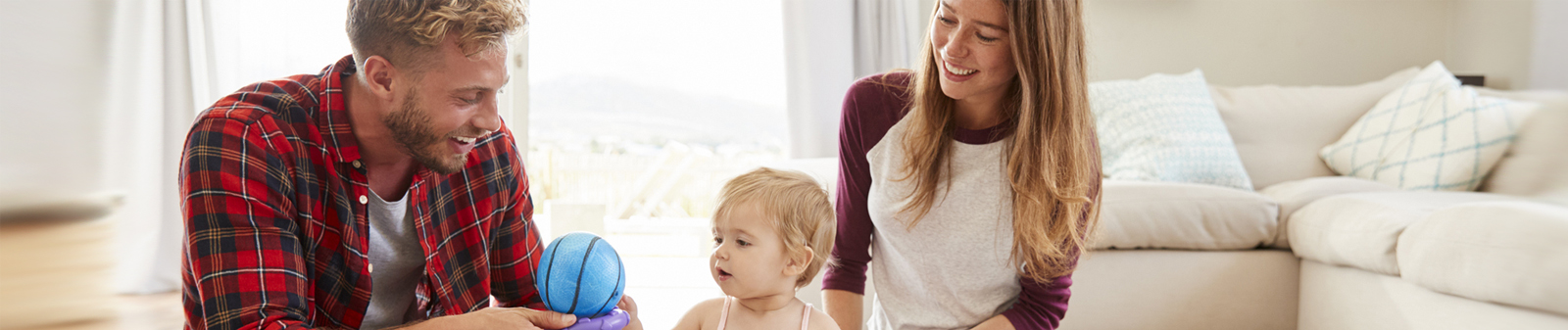 young couple with child playing with toys